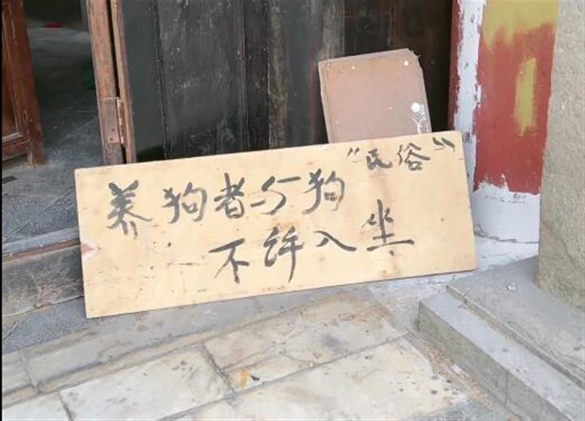 云南一景区建筑外放置“养狗者与狗不许入坐”提示牌，景区：系当地民俗